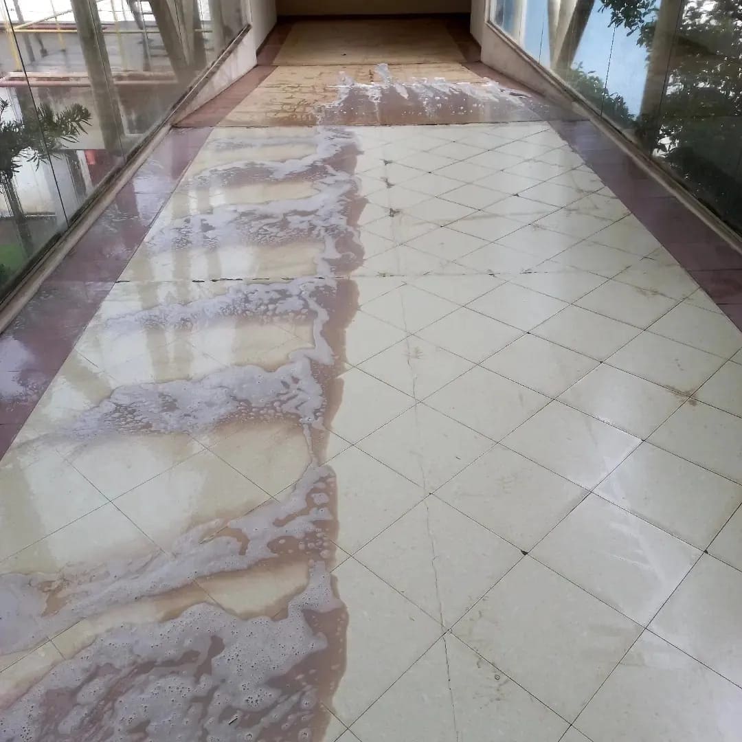 Piso de porcelanato limpo e com brilho restaurado, metade ainda por limpar ao lado